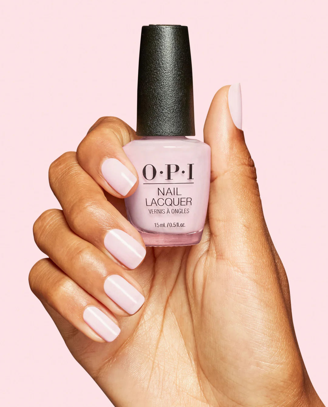 OPI Nail Polish in OPI’m a Bubble Bunny NLS061, showing the nail lacquer bottle and a hand with painted nails in a playful bubblegum pink shade