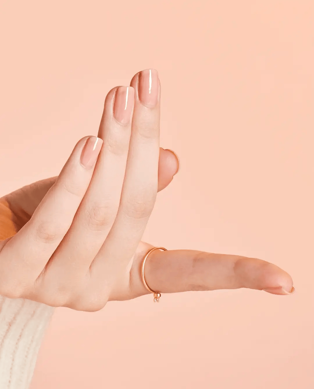 OPI Passion nail polish in vibrant coral-orange color, glossy finish, shown in a sleek glass bottle with brush applicator.