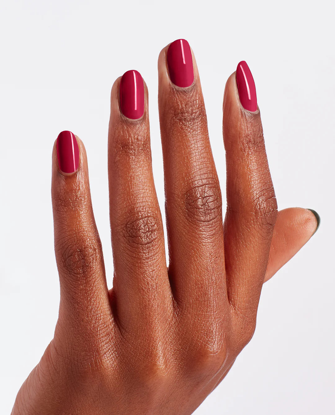 OPI Nail Polish in Red-veal Your Truth shade, featuring a glossy red nail polish bottle and a manicured hand with painted nails.