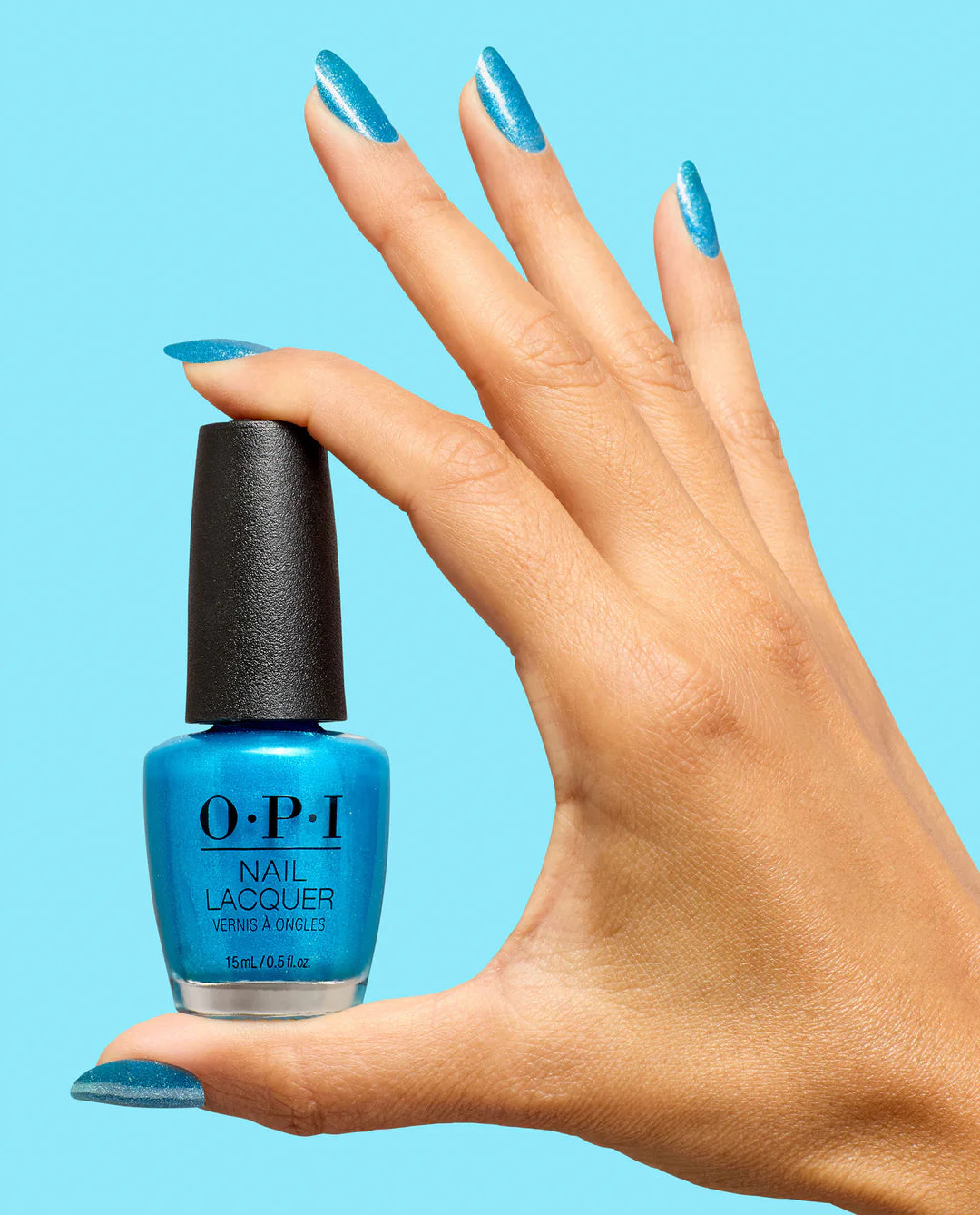 OPI Nail Polish Sky Blue Is the Limit NLS077 bottle and hand showing vibrant sky blue lacquer on nails.