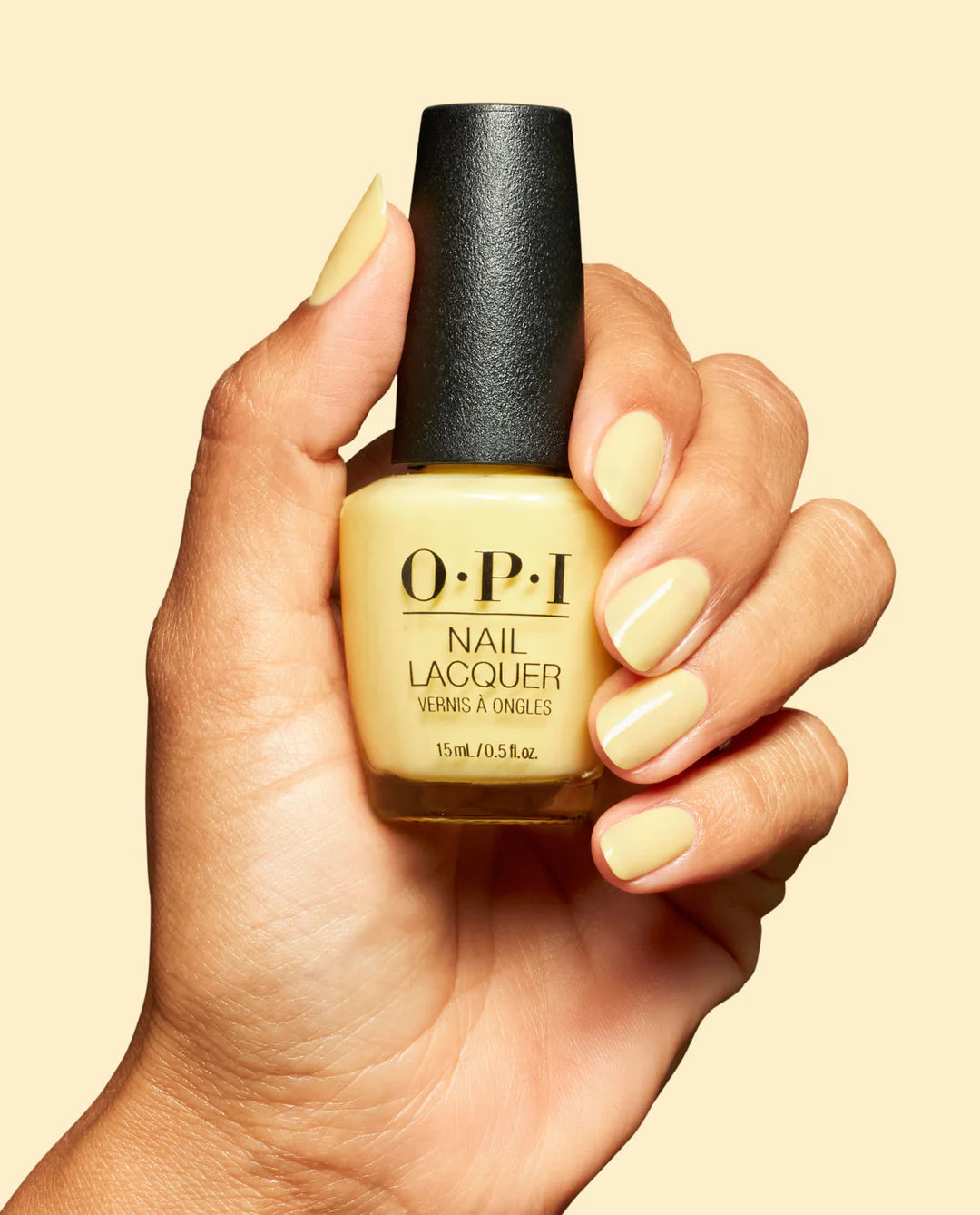 OPI Sunny Bunny NLS069 nail polish bottle and hand with painted nails showing bright yellow color, glossy finish, and stylish look.