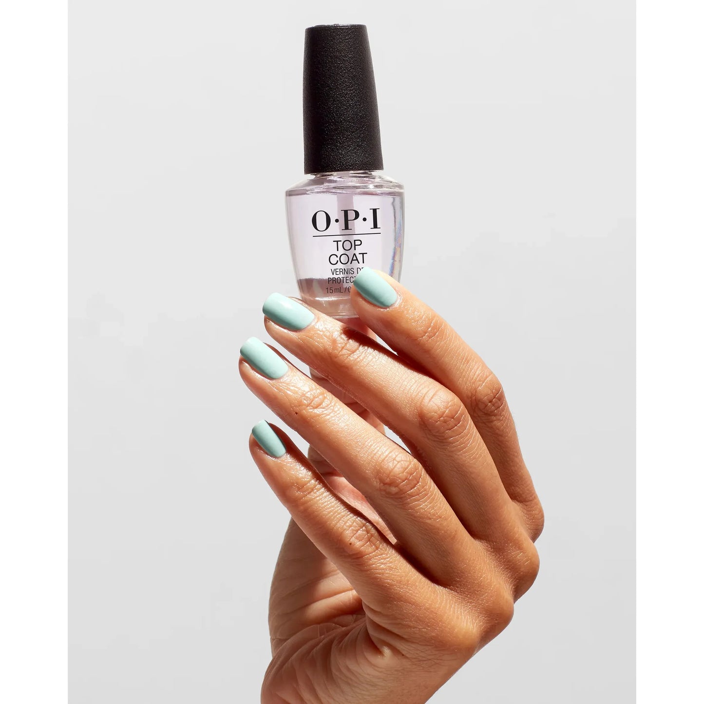 OPI Nail Polish Treatment Top Coat bottle and hand with freshly coated nails, showing the clear, glossy finish of the top coat.