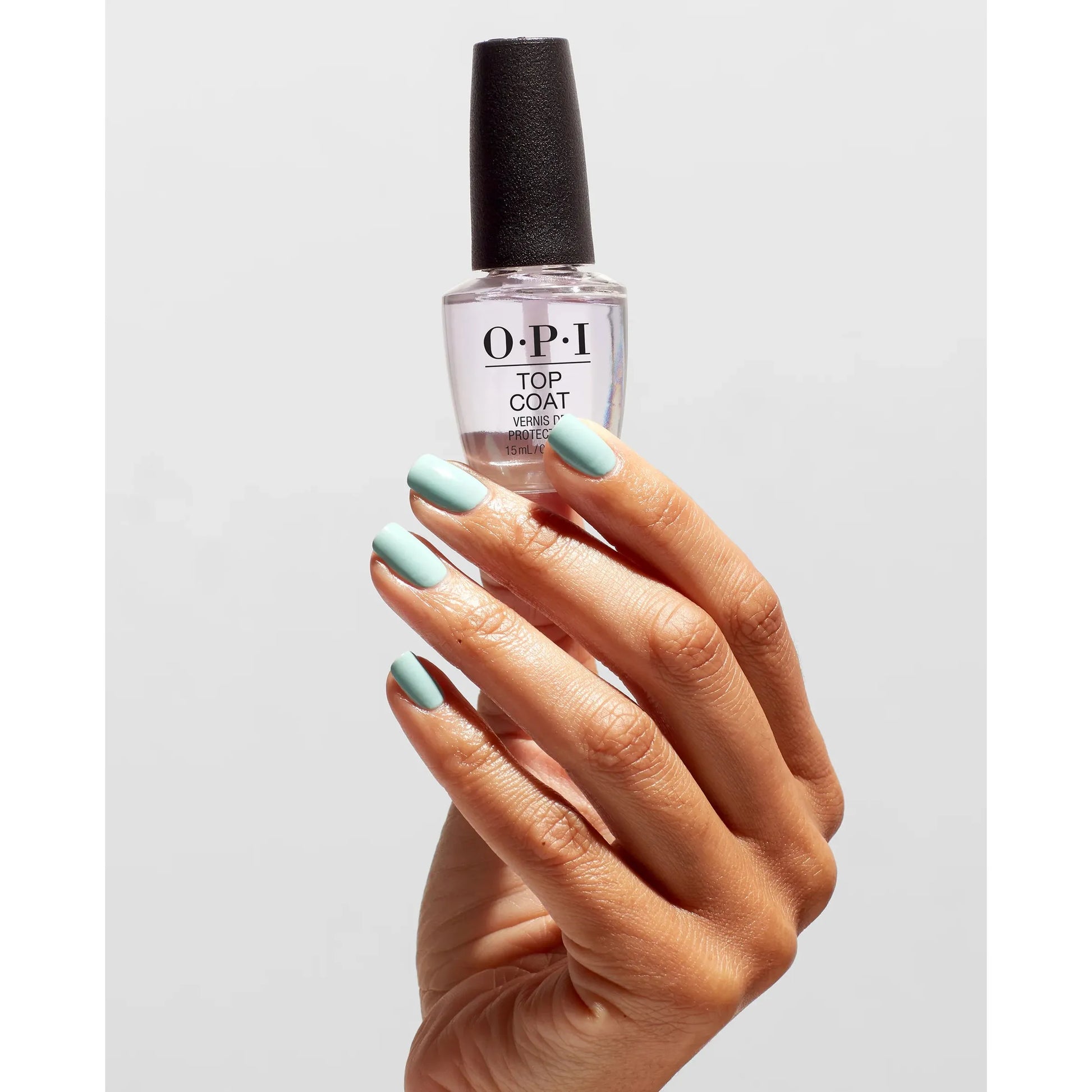 OPI Nail Polish Treatment Top Coat bottle and hand with freshly coated nails, showing the clear, glossy finish of the top coat.