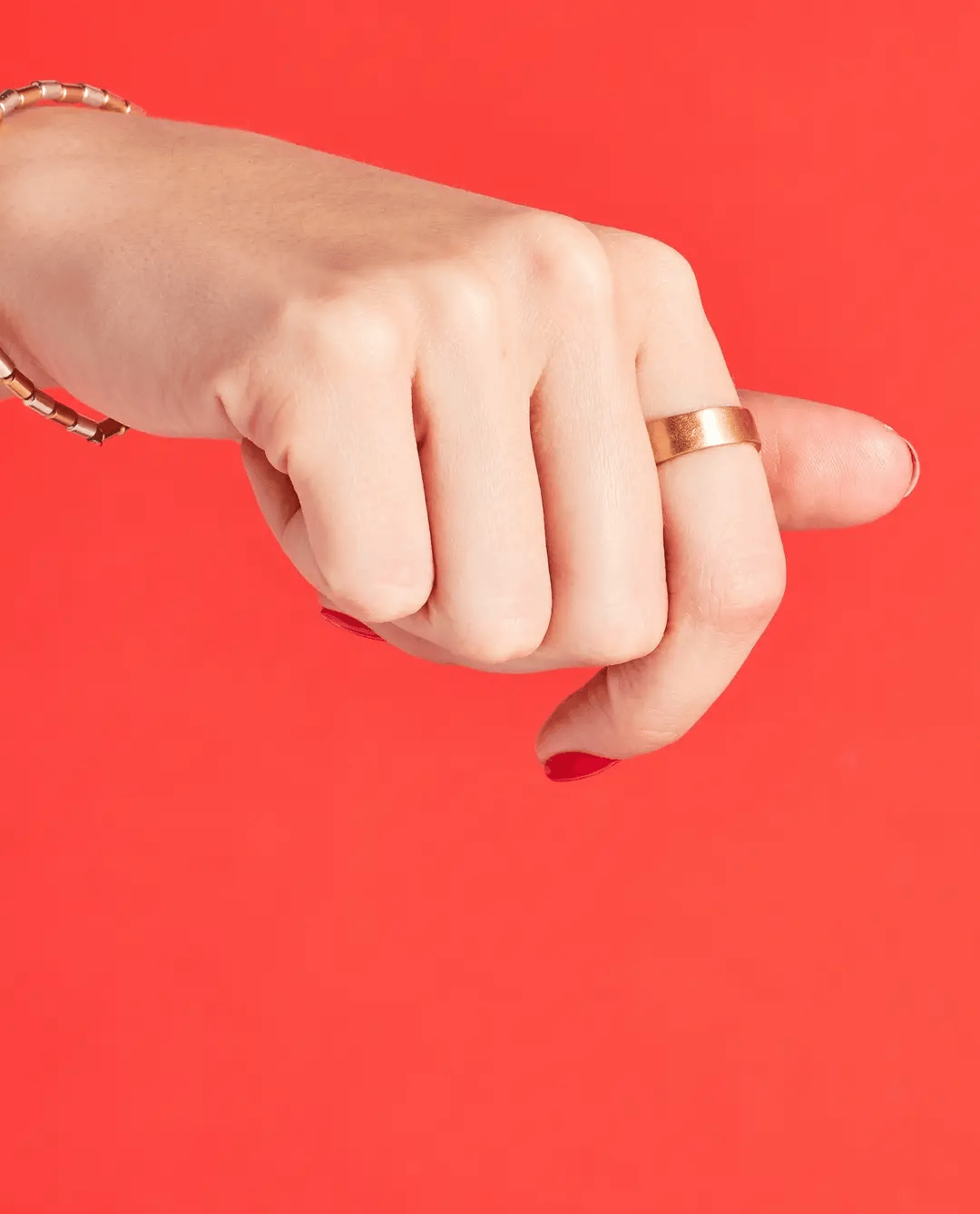 OPI Nail Polish in We Seafood And Eat It shade, a vibrant coral color, displayed in a sleek bottle with the cap off.