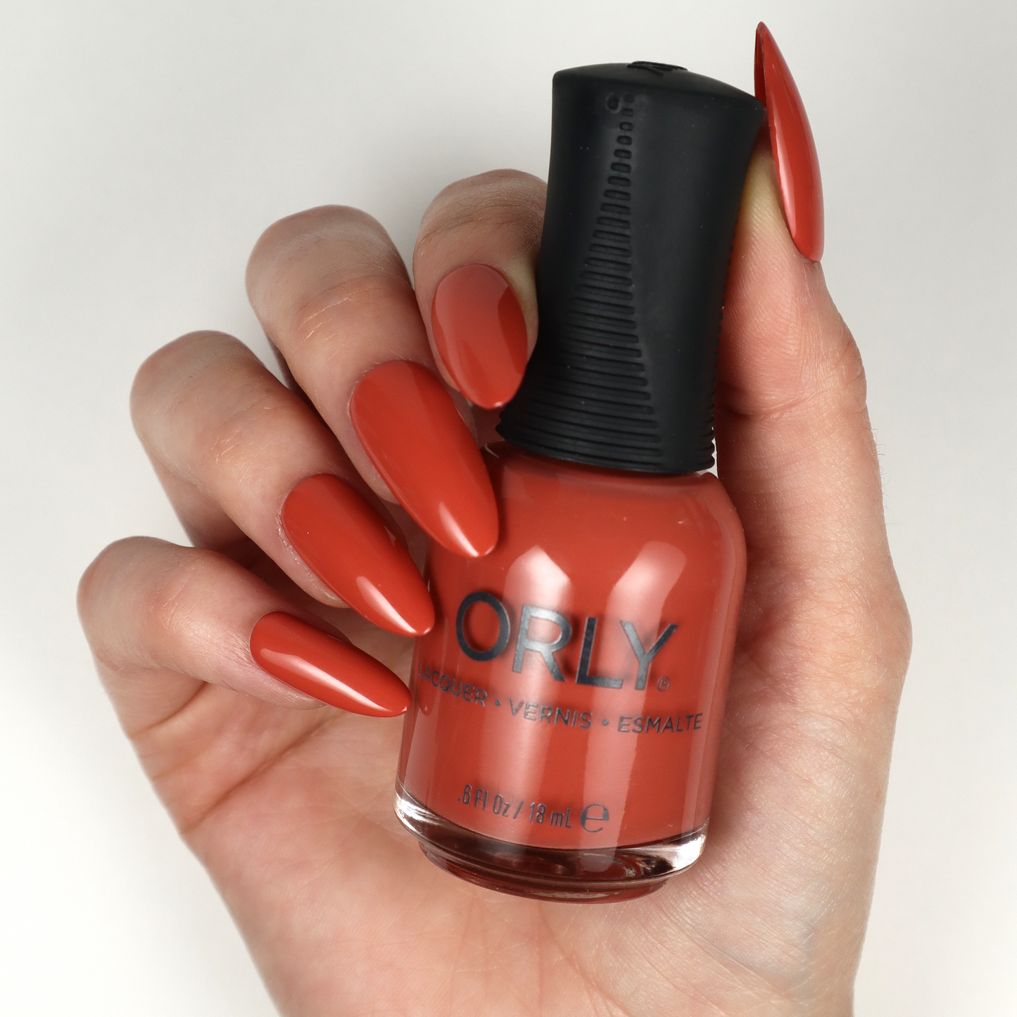Orly Nail Lacquer in In The Conservatory, a clear nail polish bottle with a black cap, showcasing the product label.