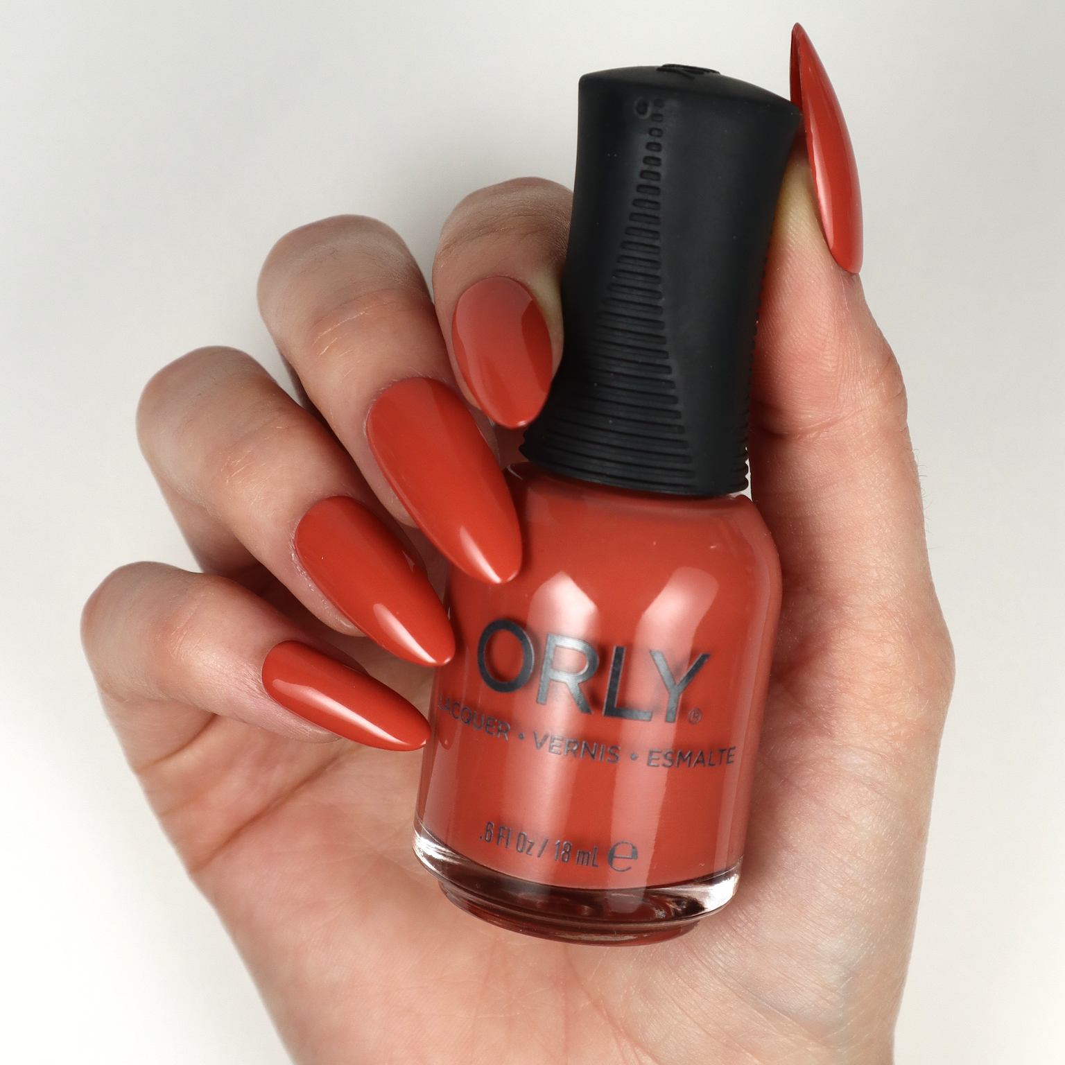 Orly Nail Lacquer in In The Conservatory, a clear nail polish bottle with a black cap, showcasing the product label.