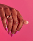 OPI Nail Polish in Telenovela Me About It #M91, vibrant nail color swatched on a hand with the bottle visible