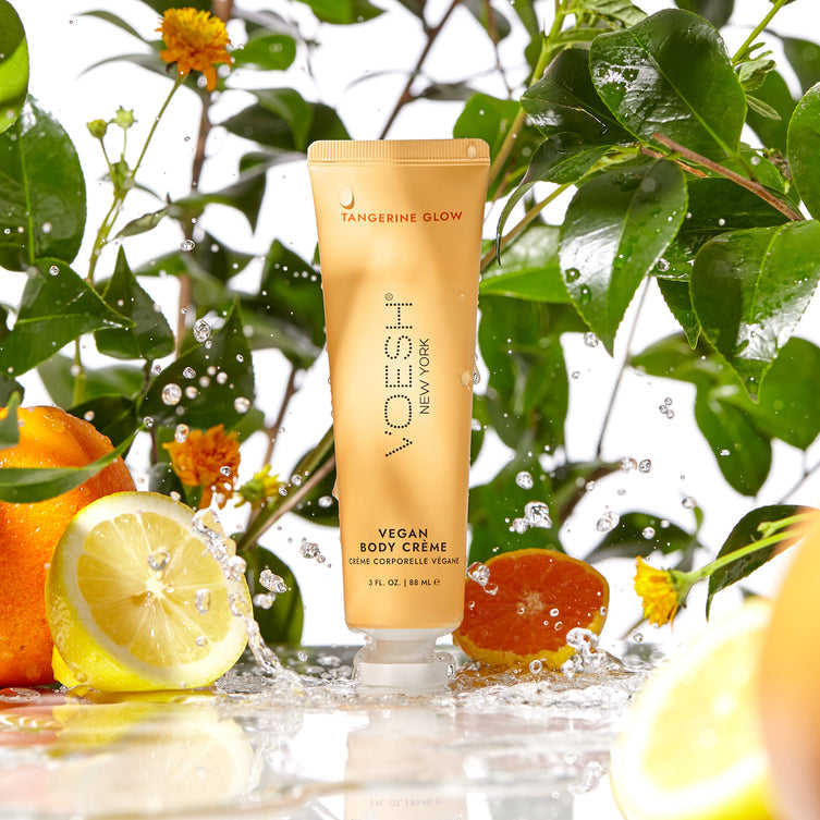 Voesh vegan body lotion in a 3oz clear container, featuring a vibrant tangerine scent and smooth moisturizing texture
