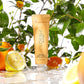 Voesh vegan body lotion in a 3oz clear container, featuring a vibrant tangerine scent and smooth moisturizing texture