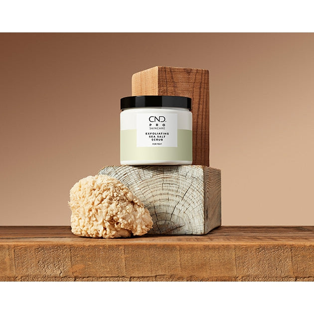 CND Pro Skincare exfoliating sea salt scrub in a jar, showing the textured salt formula and product label.